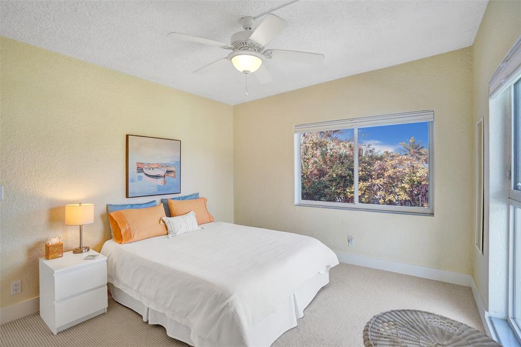 5700 Old Ocean Boulevard, Unit X Ocean Ridge, FL 33435 - Photo 18 of 49 a bedroom with a bed and a painting on the wall