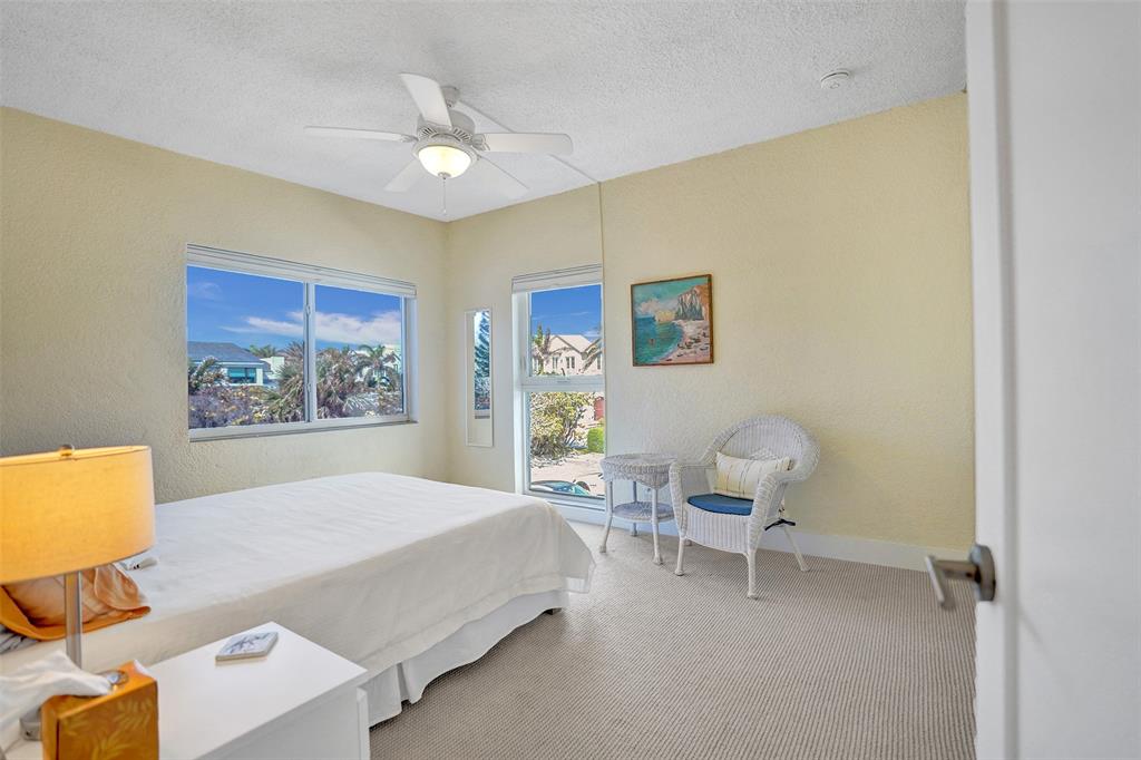 5700 Old Ocean Boulevard, Unit X Ocean Ridge, FL 33435 - Photo 22 of 49 a bedroom with a bed and a chair
