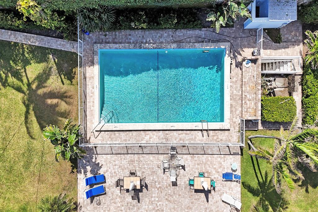 5700 Old Ocean Boulevard, Unit X Ocean Ridge, FL 33435 - Photo 31 of 49 a view of a garden with a chair and potted plants