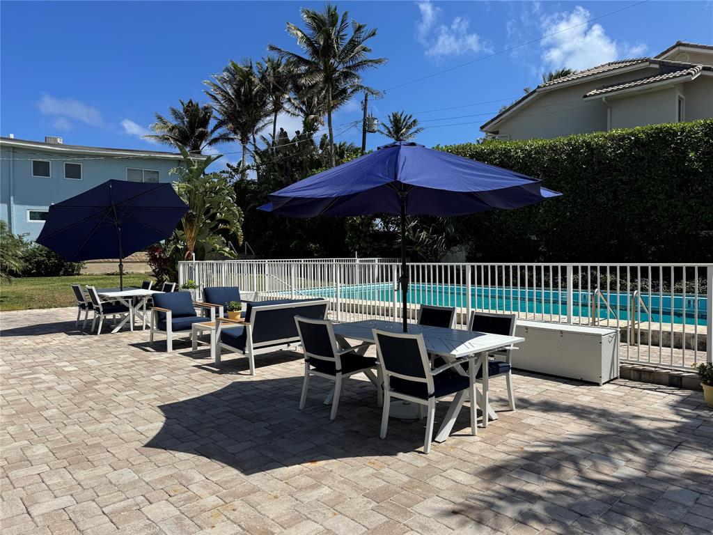 5700 Old Ocean Boulevard, Unit X Ocean Ridge, FL 33435 - Photo 33 of 49 a view of a tables and chairs in patio