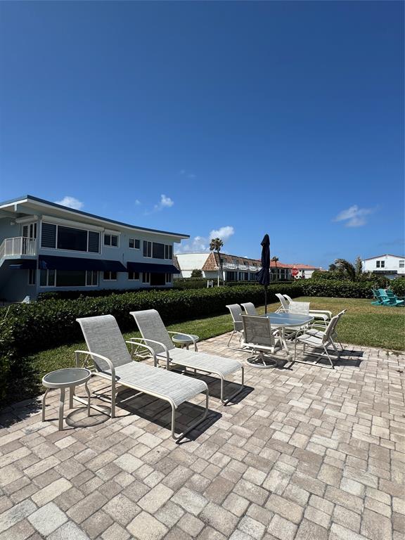 5700 Old Ocean Boulevard, Unit X Ocean Ridge, FL 33435 - Photo 39 of 49 a roof deck with table and chairs a barbeque