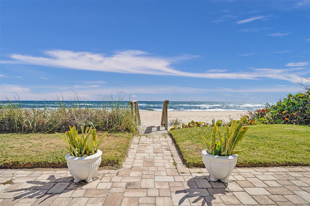 5700 Old Ocean Boulevard, Unit X Ocean Ridge, FL 33435 - Photo 48 of 49 a view of a patio with lawn chairs and a potted plant