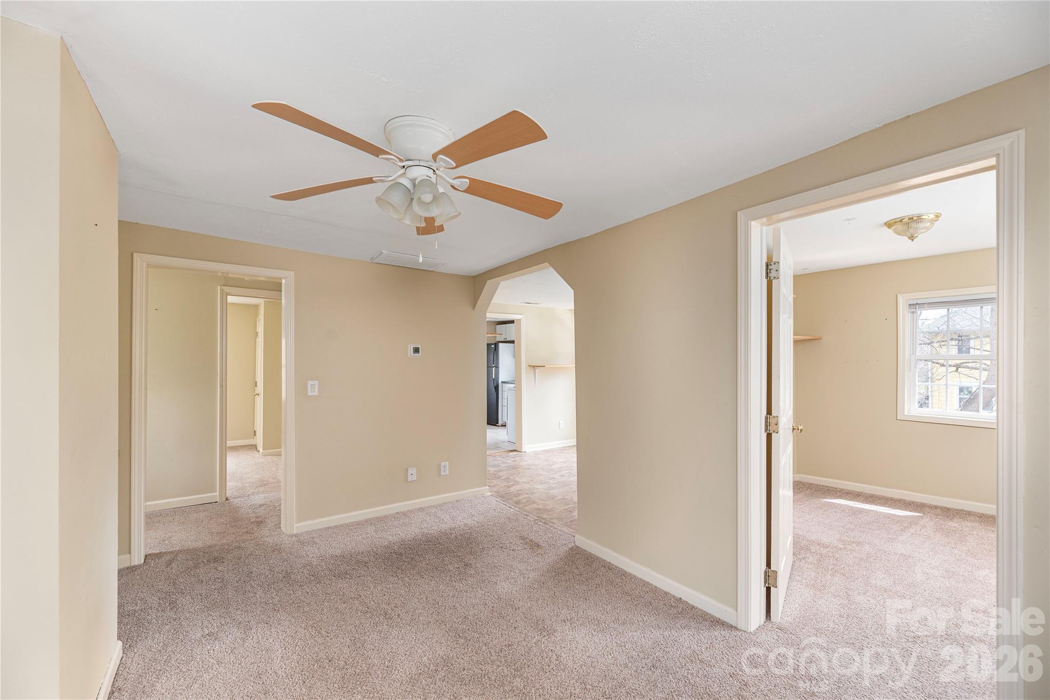 448 Sand Hill Road Asheville, NC 28806 - Photo 16 of 24 a view of a big room with wooden floor and a ceiling fan