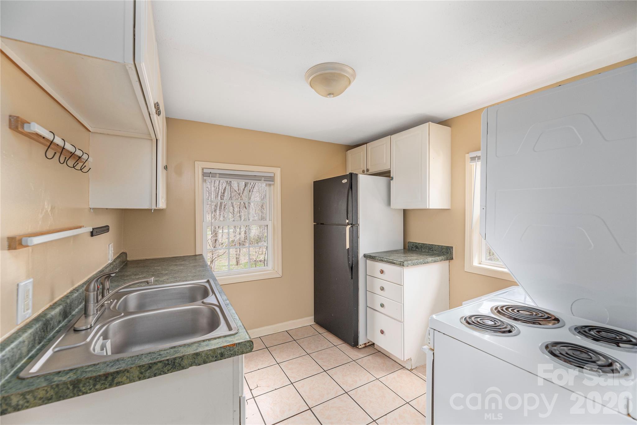 448 Sand Hill Road Asheville, NC 28806 - Photo 18 of 24 a kitchen that has a sink stainless steel appliances a counter space and a window