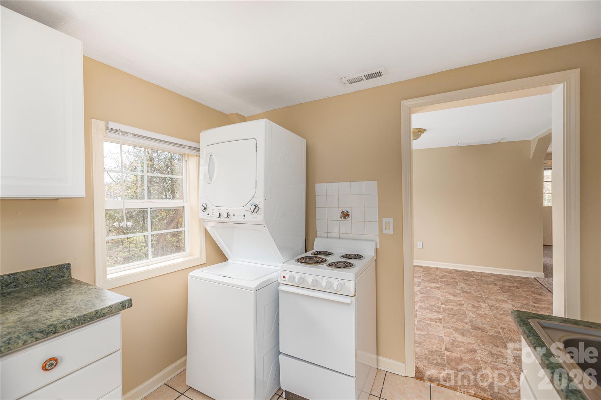 448 Sand Hill Road Asheville, NC 28806 - Photo 19 of 24 a view of washer and dryer with kitchen in the background