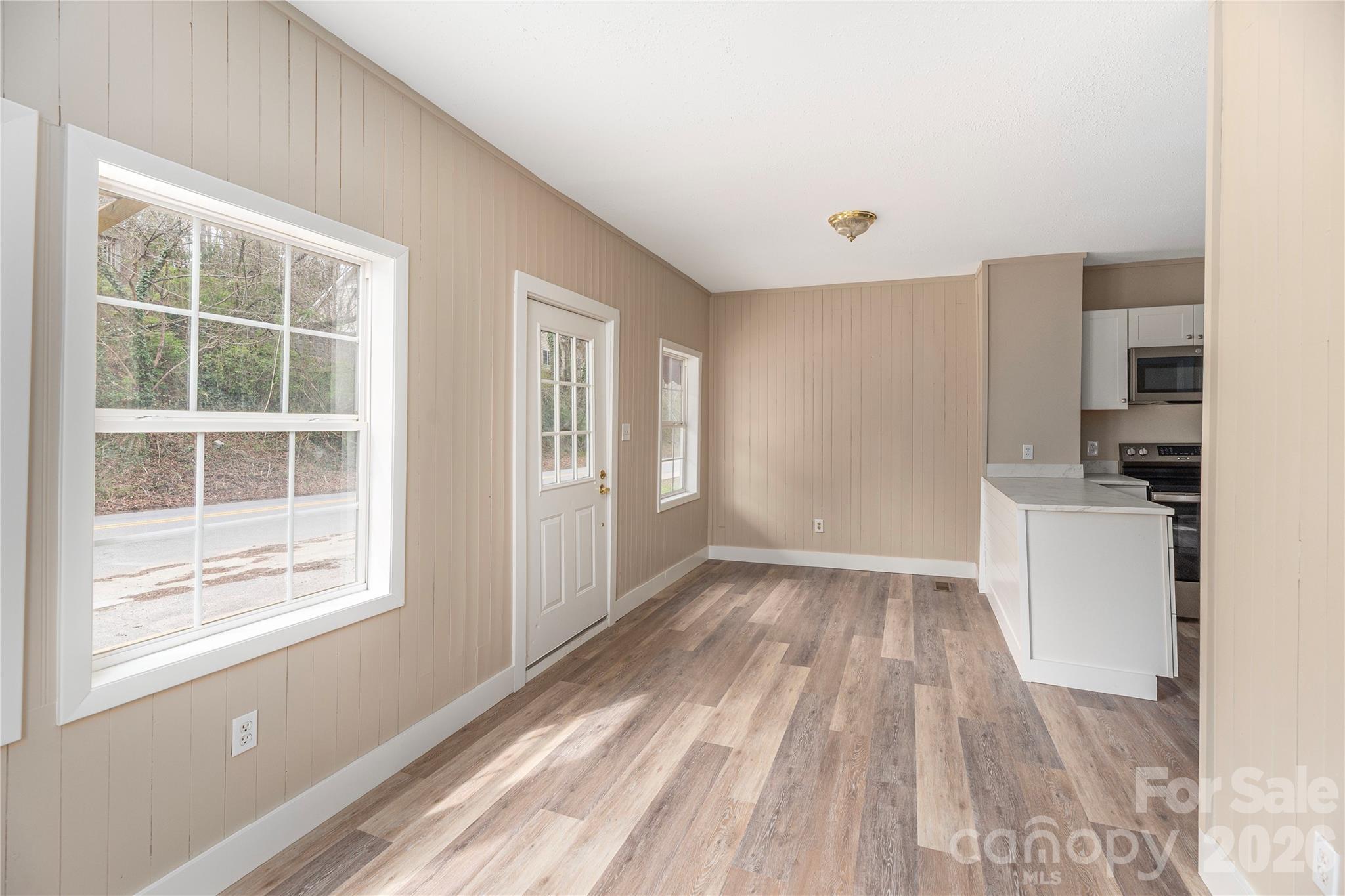 448 Sand Hill Road Asheville, NC 28806 - Photo 5 of 24 a view of empty room with wooden floor and window