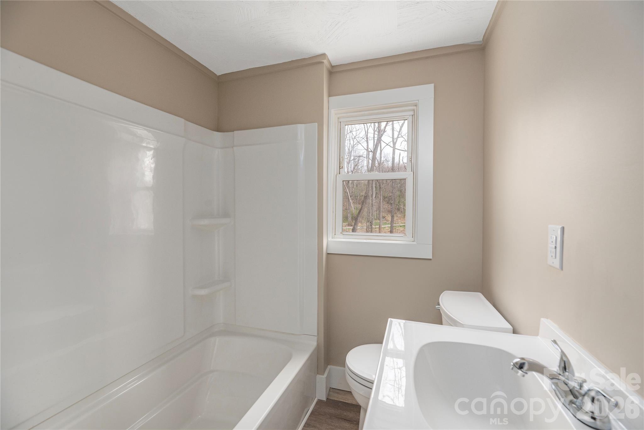 448 Sand Hill Road Asheville, NC 28806 - Photo 9 of 24 a bathroom with a toilet and a bathtub