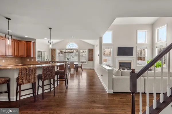 a dining room with furniture entryway and wooden floor