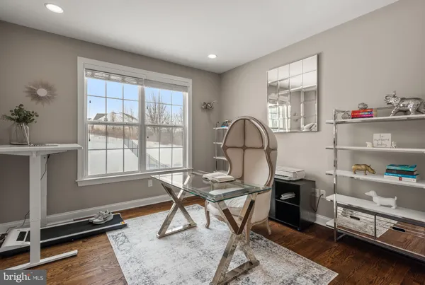 a view of a workspace with furniture and a window