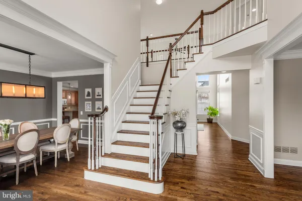 a view of entryway and dining room with wooden floor