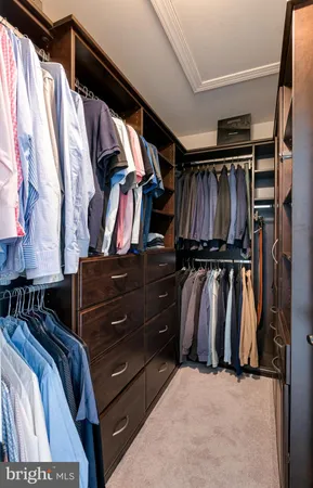 a view of walk in closet with clothes