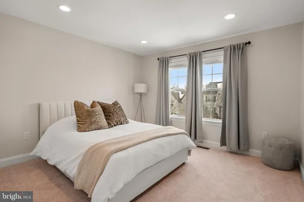 a spacious bedroom with a bed and a large window