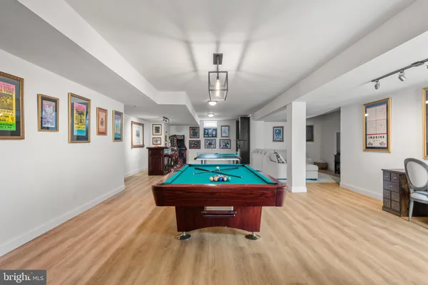 a living room with furniture and a pool table