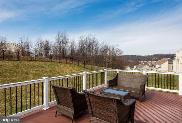 a view of a balcony with wooden floor and fence