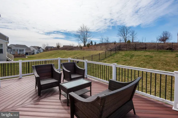 a view of a patio on wooden deck with a lake
