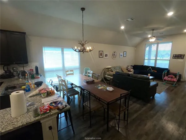 a kitchen with a table and chairs in it