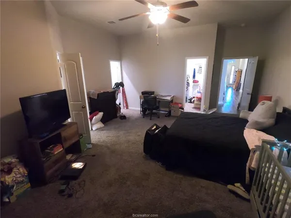 a living room with furniture a lamp and a flat screen tv