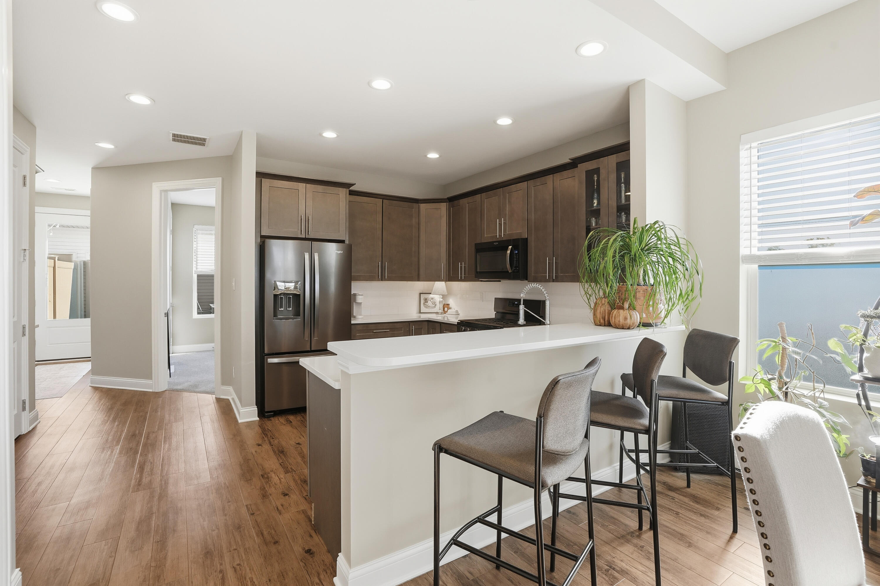 310 North Indiana Avenue Crown Point, IN 46307 - Photo 11 of 29 a kitchen with refrigerator a microwave and wooden floor