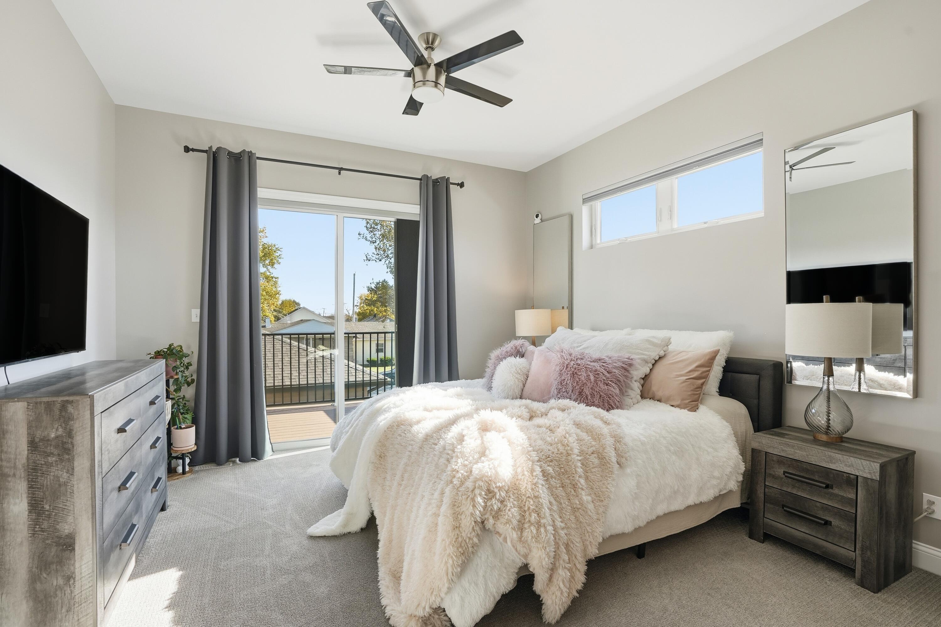 310 North Indiana Avenue Crown Point, IN 46307 - Photo 16 of 29 a bedroom with a bed and a flat tv screen on dresser