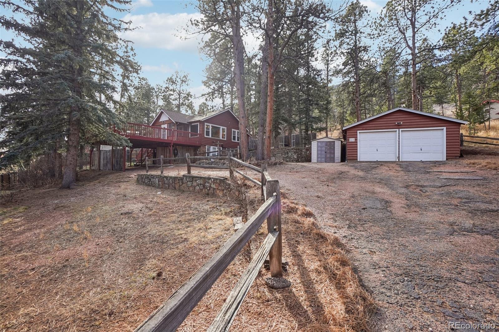 a view of a house with a yard and large tree