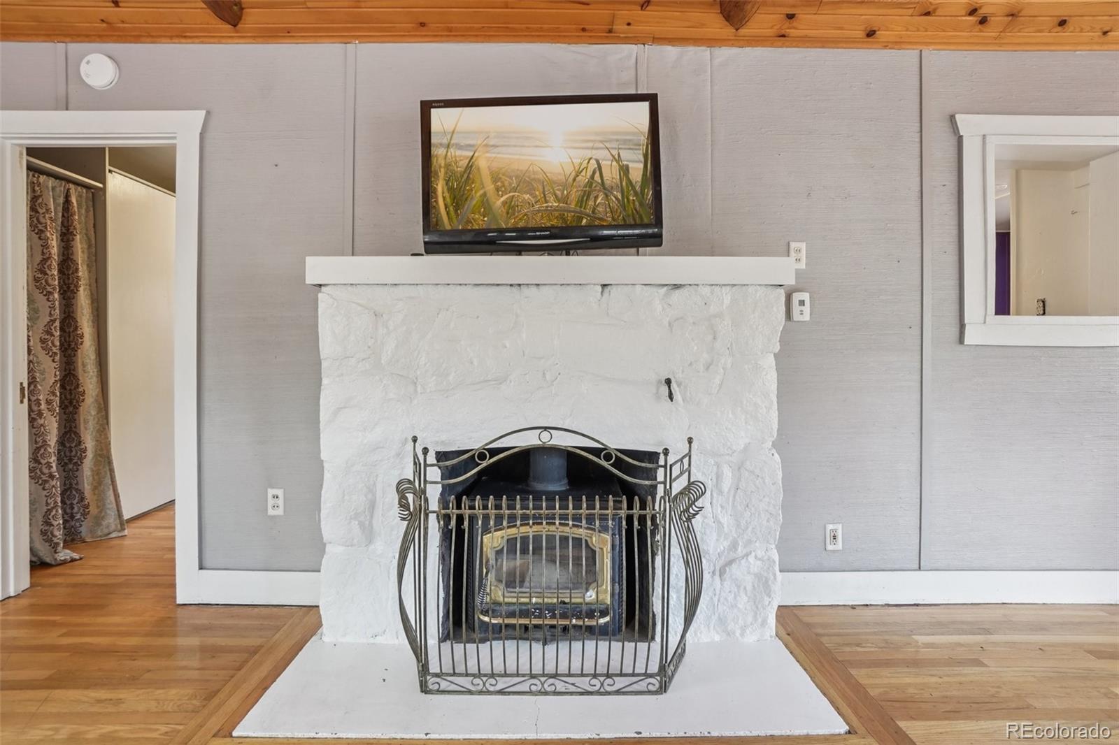 9025 Picabo Road Cascade, CO 80809 - Photo 11 of 44 a view of a livingroom with a bench and wooden floor