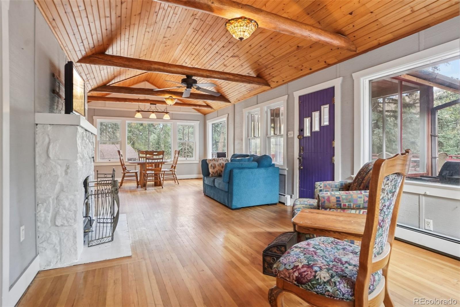 9025 Picabo Road Cascade, CO 80809 - Photo 12 of 44 a living room with furniture a wooden floor and next to a window