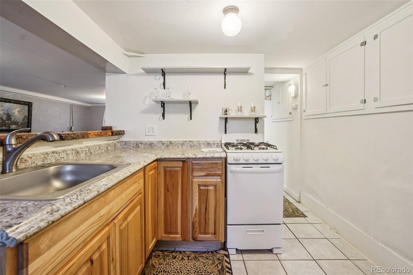 9025 Picabo Road Cascade, CO 80809 - Photo 31 of 44 a kitchen with a sink stove and cabinets