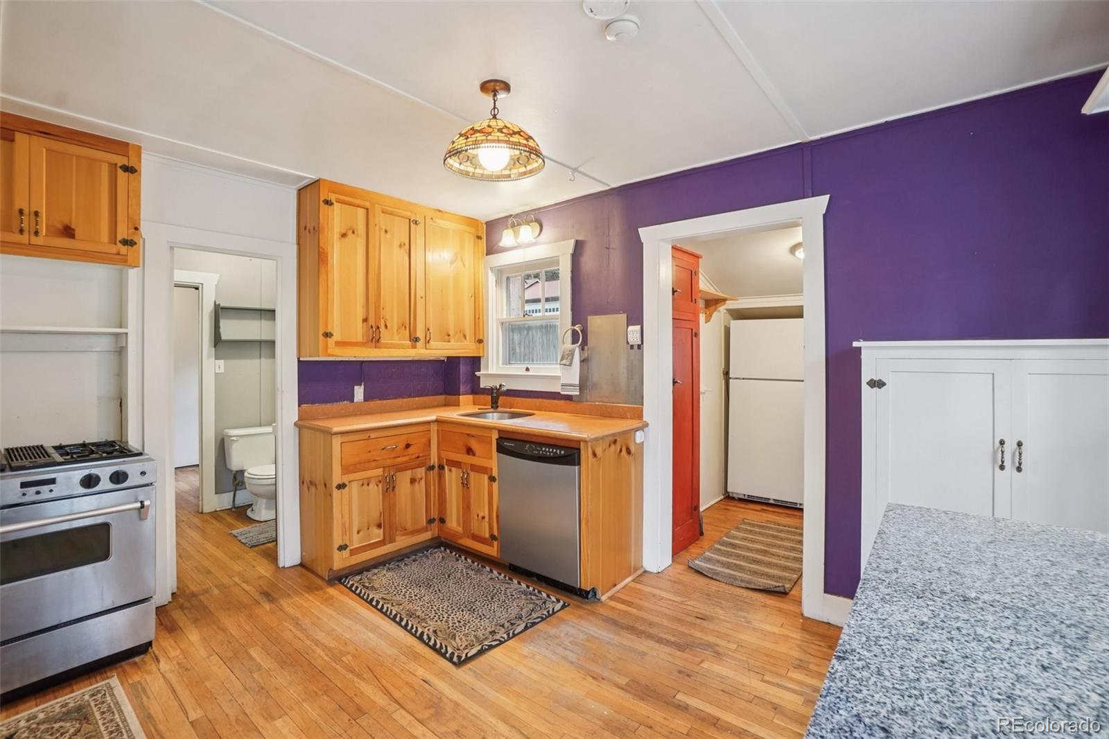 9025 Picabo Road Cascade, CO 80809 - Photo 4 of 44 a kitchen with stainless steel appliances granite countertop a stove a sink and a refrigerator