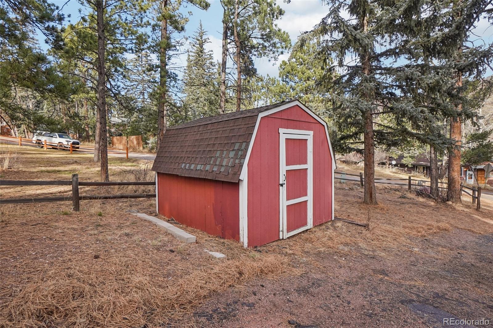 9025 Picabo Road Cascade, CO 80809 - Photo 43 of 44 a view of a barn in the middle of a yard