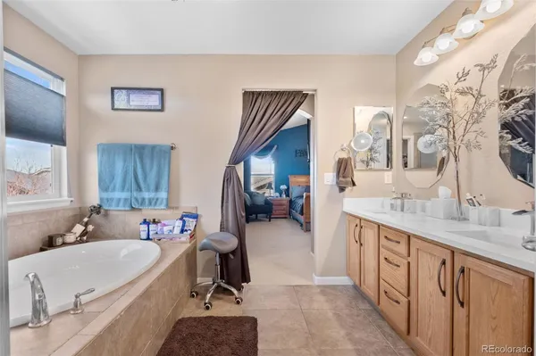 a bathroom with a tub sink and mirror