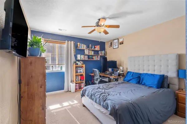 a spacious bedroom with a bed and a chandelier