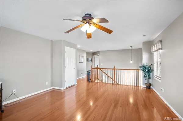 a view of empty room with wooden floor