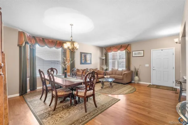 a view of a dining room with furniture window and wooden floor