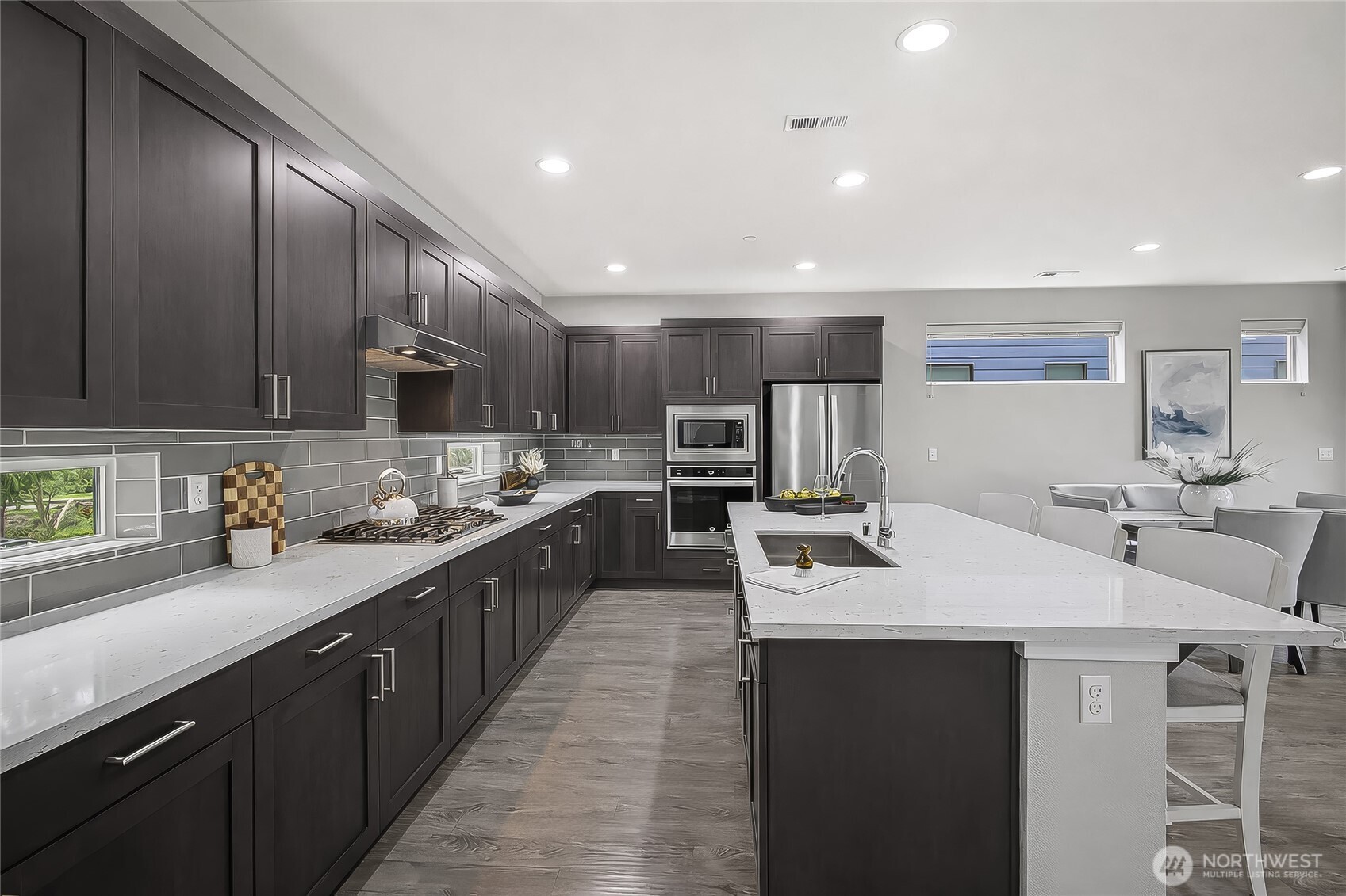 130 198th Street Southeast, Unit 5 Bothell, WA 98012 - Photo 9 of 40 a kitchen with kitchen island granite countertop a sink stainless steel appliances and cabinets