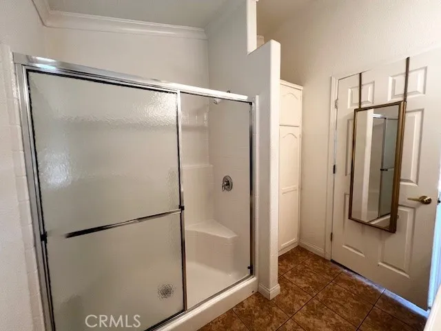 a bathroom with a glass shower door