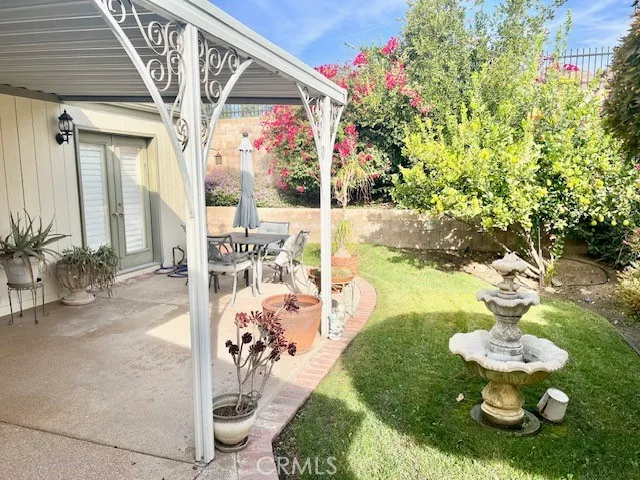 a view of a porch with dining table and chairs