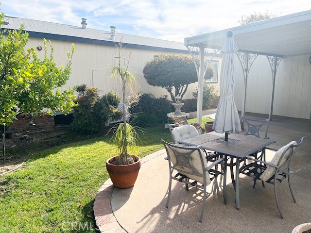 27600 Atlantic Avenue, Unit 427 Highland, CA 92346 - Photo 5 of 20 a view of outdoor dining space with a table and chairs
