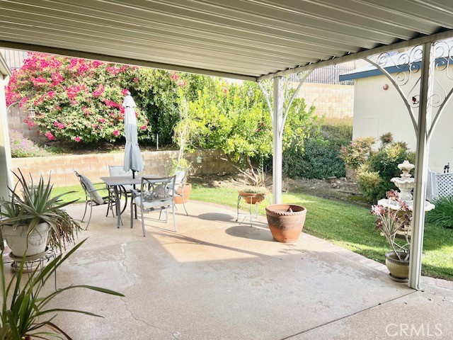 27600 Atlantic Avenue, Unit 427 Highland, CA 92346 - Photo 6 of 20 a view of a patio with a table chairs and garden