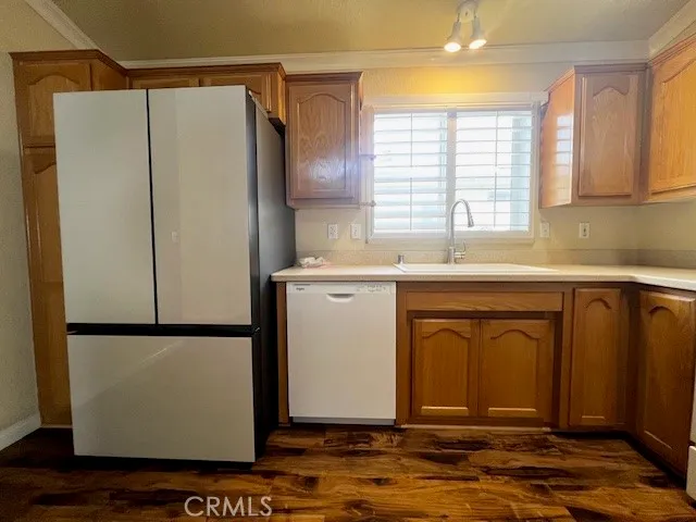 a kitchen with stainless steel appliances granite countertop a refrigerator and a sink