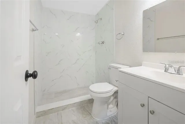 a bathroom with a sink toilet and shower