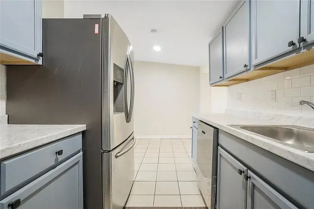 a kitchen with a sink and refrigerator