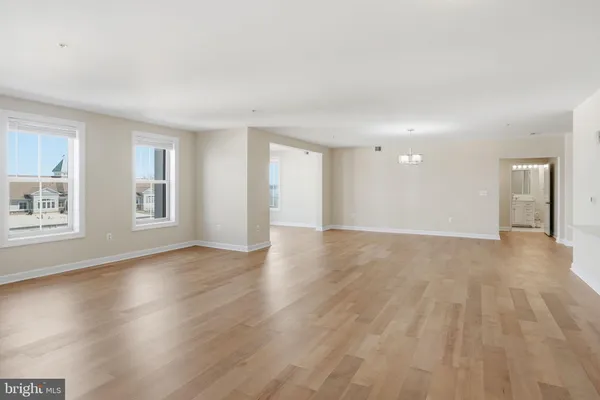 a kitchen that has a sink a stove in it and wooden floors