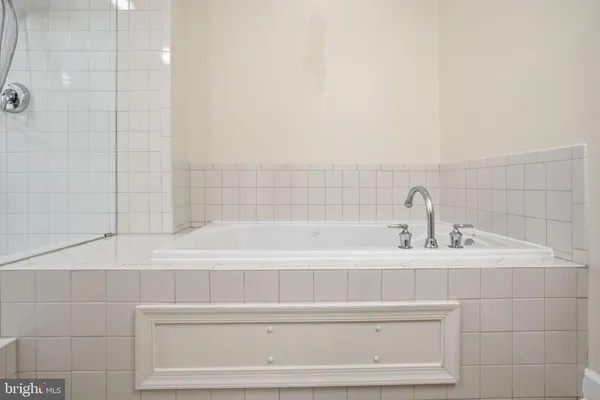 a bathroom with a double vanity sink a toilet and shower