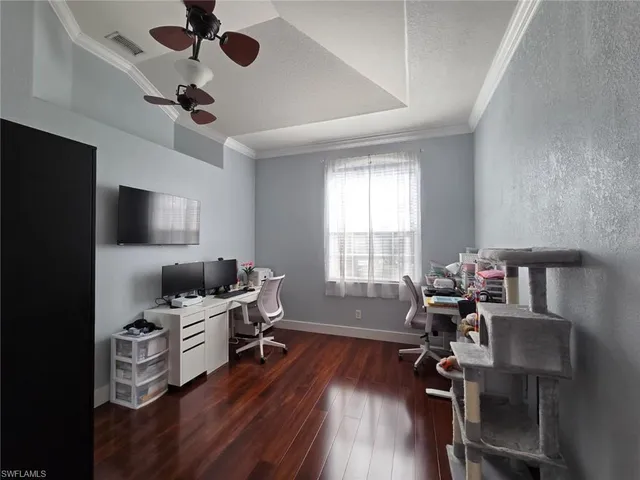 a view of a workspace with furniture and a window