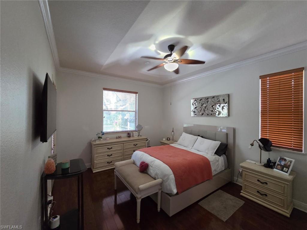 15437 Cortona Way Naples, FL 34120 - Photo 19 of 29 a bedroom with a bed a dresser and chair