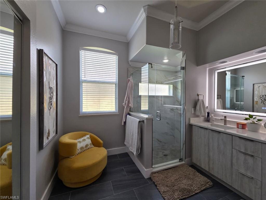 15437 Cortona Way Naples, FL 34120 - Photo 21 of 29 a bathroom with a sink a mirror and a shower