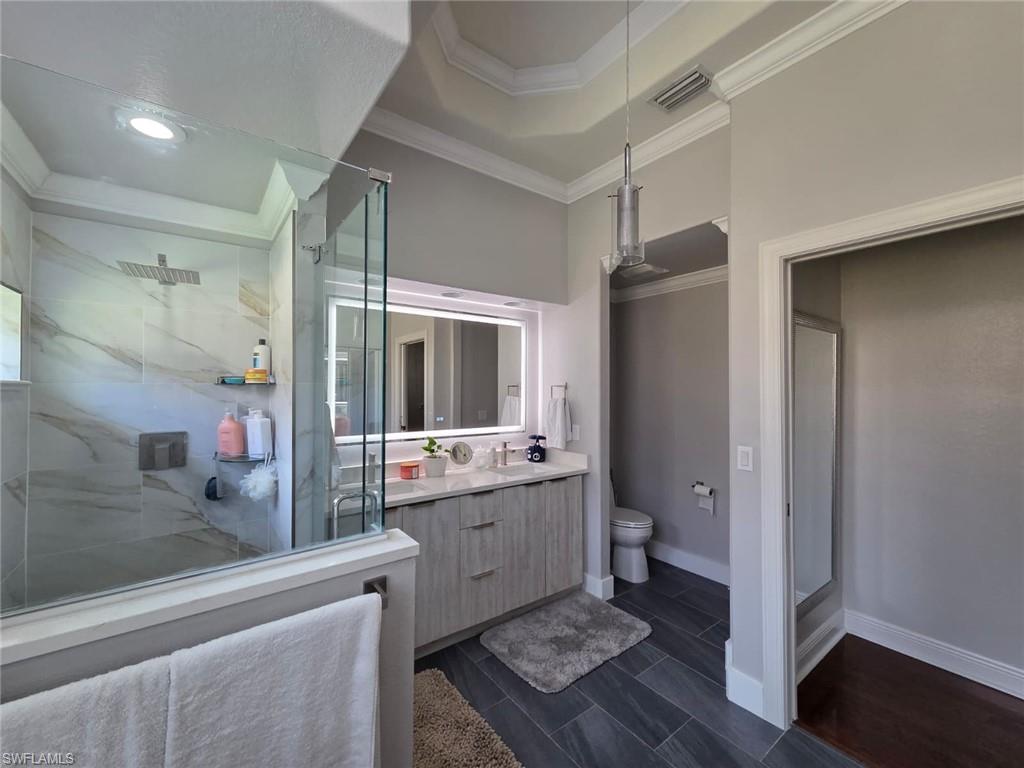 15437 Cortona Way Naples, FL 34120 - Photo 22 of 29 a bathroom with a granite countertop sink mirror and toilet