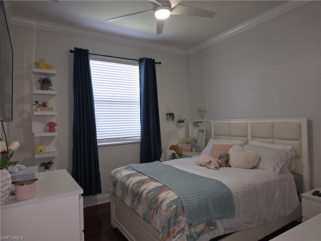 15437 Cortona Way Naples, FL 34120 - Photo 23 of 29 a bedroom with a bed and a chandelier