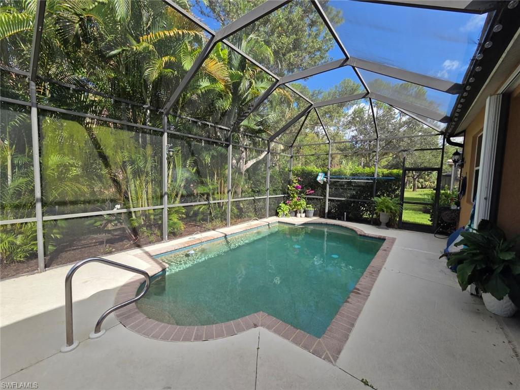 15437 Cortona Way Naples, FL 34120 - Photo 6 of 29 a view of a swimming pool with a porch