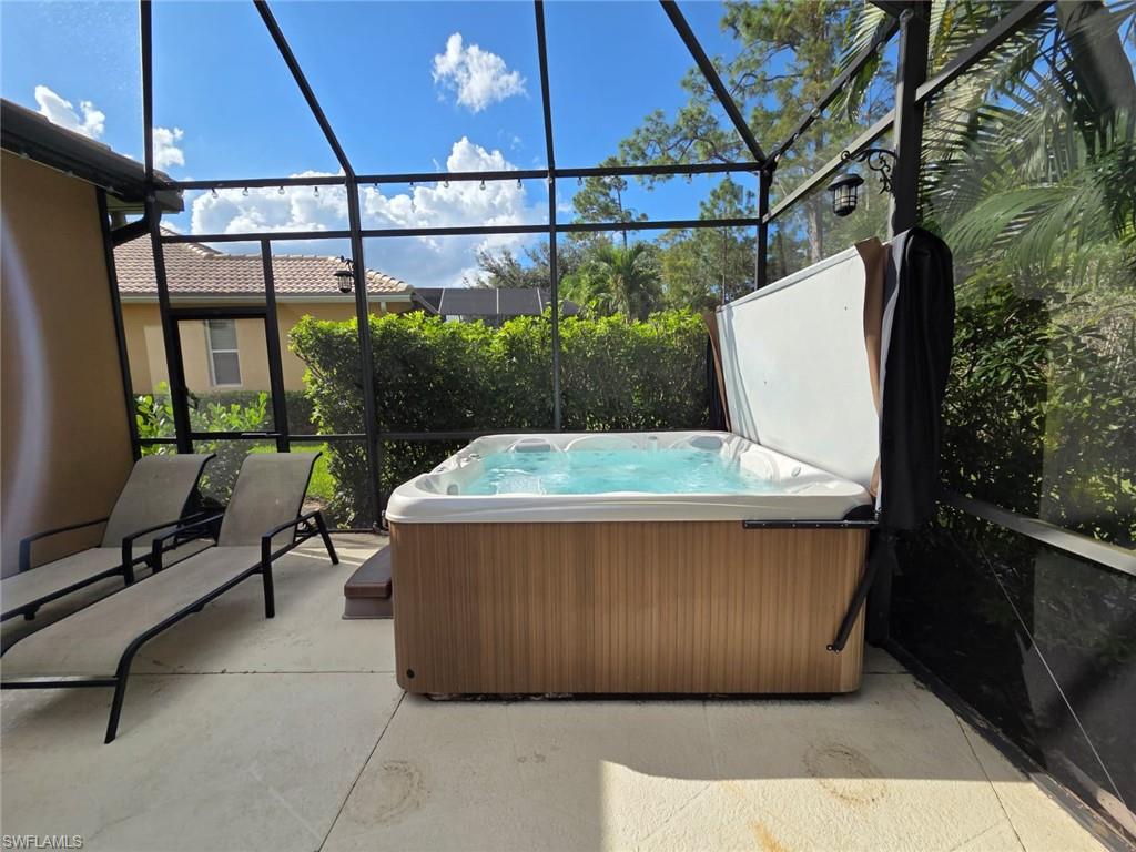 15437 Cortona Way Naples, FL 34120 - Photo 8 of 29 a living room with a couch and a table